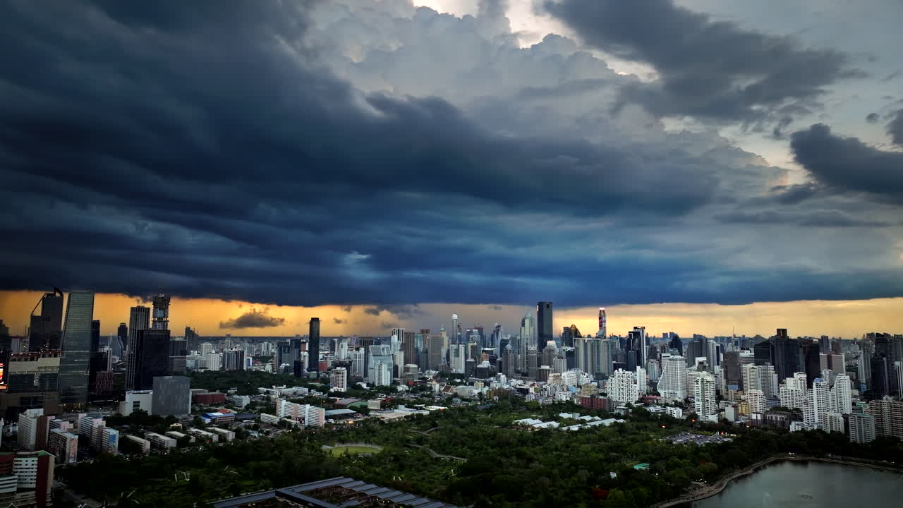Bangkok skyline with dramatic cloudscape view from Benchakitti Park, aerial