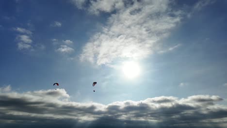 a pair of paragliders soaring over torrey pines glider port in san diego, california (usa)