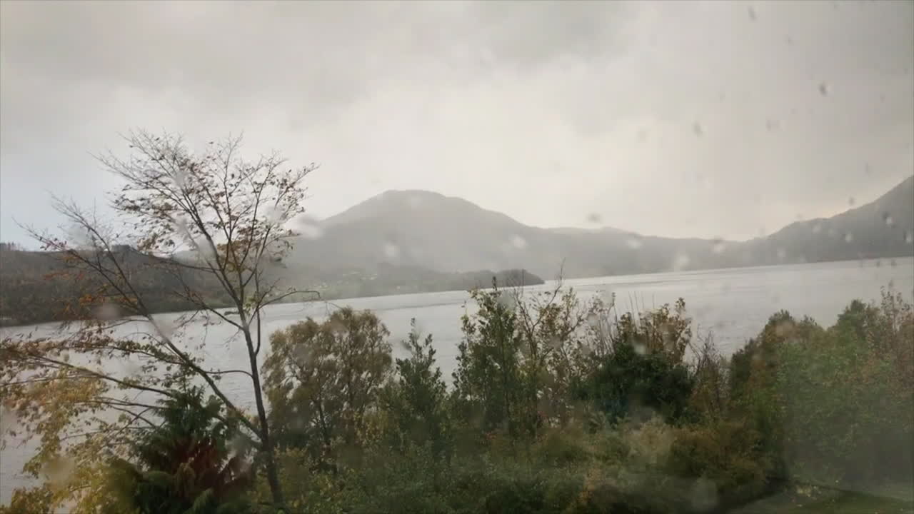 Rainy motion timelapse in Norwegian fjords and moutains. Filmed inside through wet window on motorised slider.