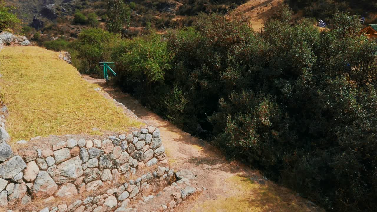 Ancient Inca stone terraces and pathways at Inkilltambo Archaeological Site, Cusco, Peru.