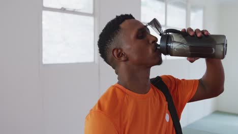 mixed race man drinking water