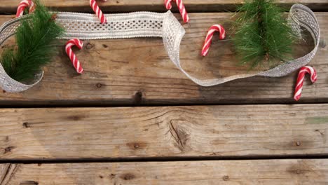 Candy-cane-with-christmas-decoration-on-wooden-table-4k