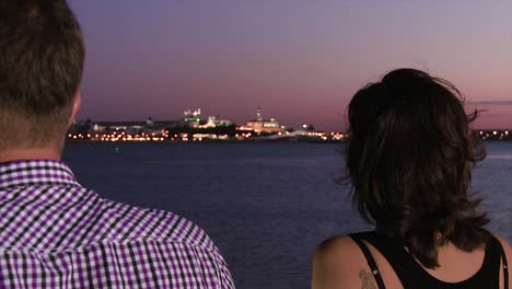 couple watching city skyline at sunset