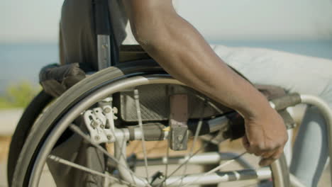 closeup of black man with paraplegia riding wheelchair