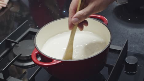 slow motion shot of flour being added to sauce