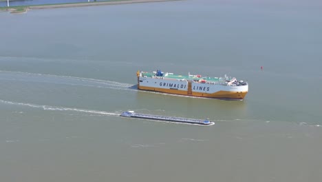 wide view of grimaldi lines ship cruising at westerschelde, aerial