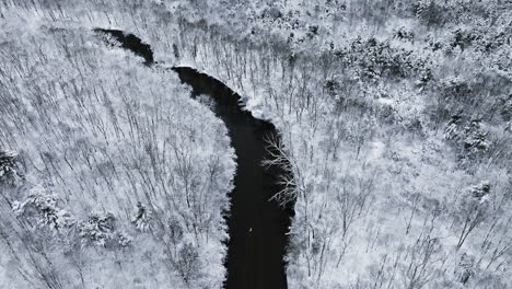 Cinematic-drone-perspective-showcasing-the-Huron-River-Valley-blanketed-in-snow-from-above