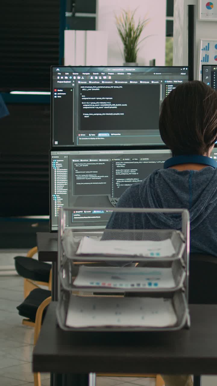 Vertical video: Diverse team of software engineers analyzing code on wall screen tv