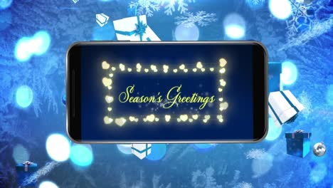 Animation-of-season's-greetings-text-with-fairy-lights-on-smartphone-screen-on-blue-background