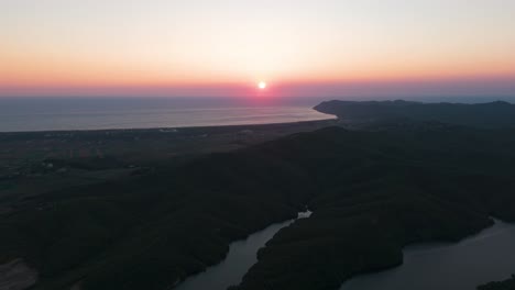 Colorful-sunset-over-Adriatic-sea-and-dramatic-shadow-on-hillside-near-shore