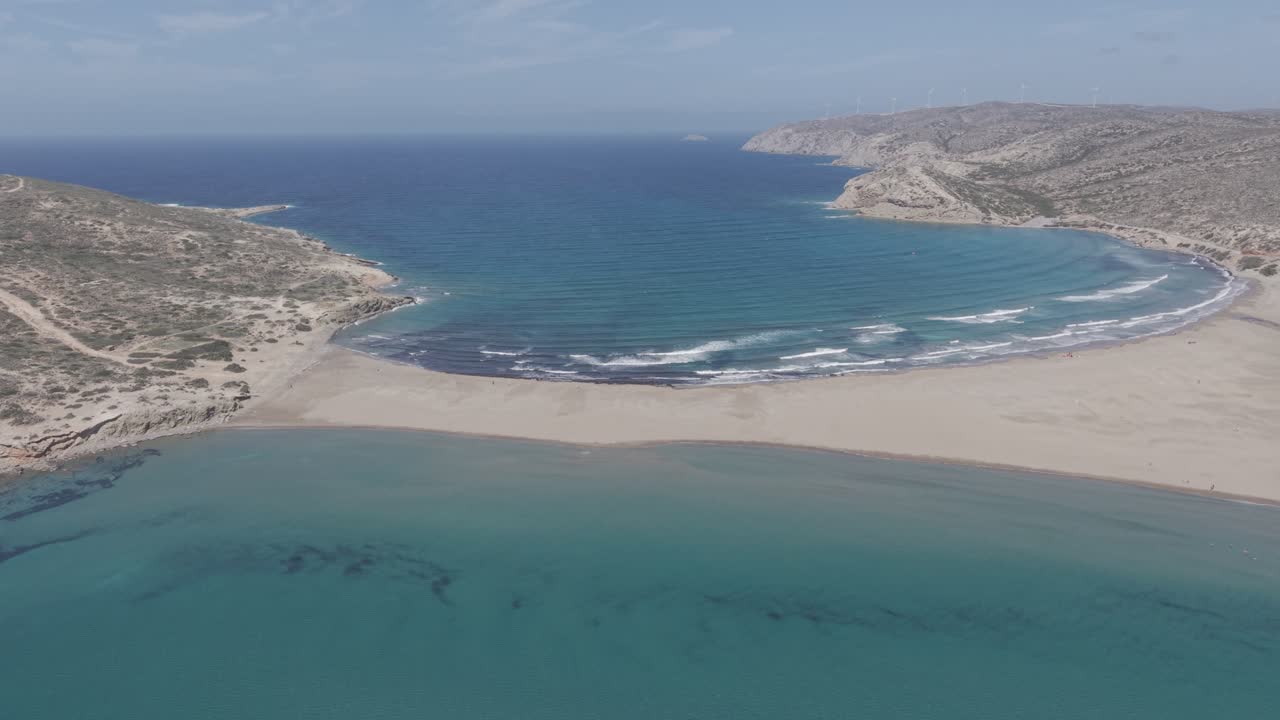 Aerial footage capturing wind surfers and kite surfers at the famous Prasonisi beach in Rhodes, Greece on a sunny, windy day. D-Log M.