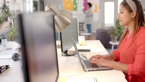 Caucasian-casual-businesswoman-using-laptop-in-office,-slow-motion