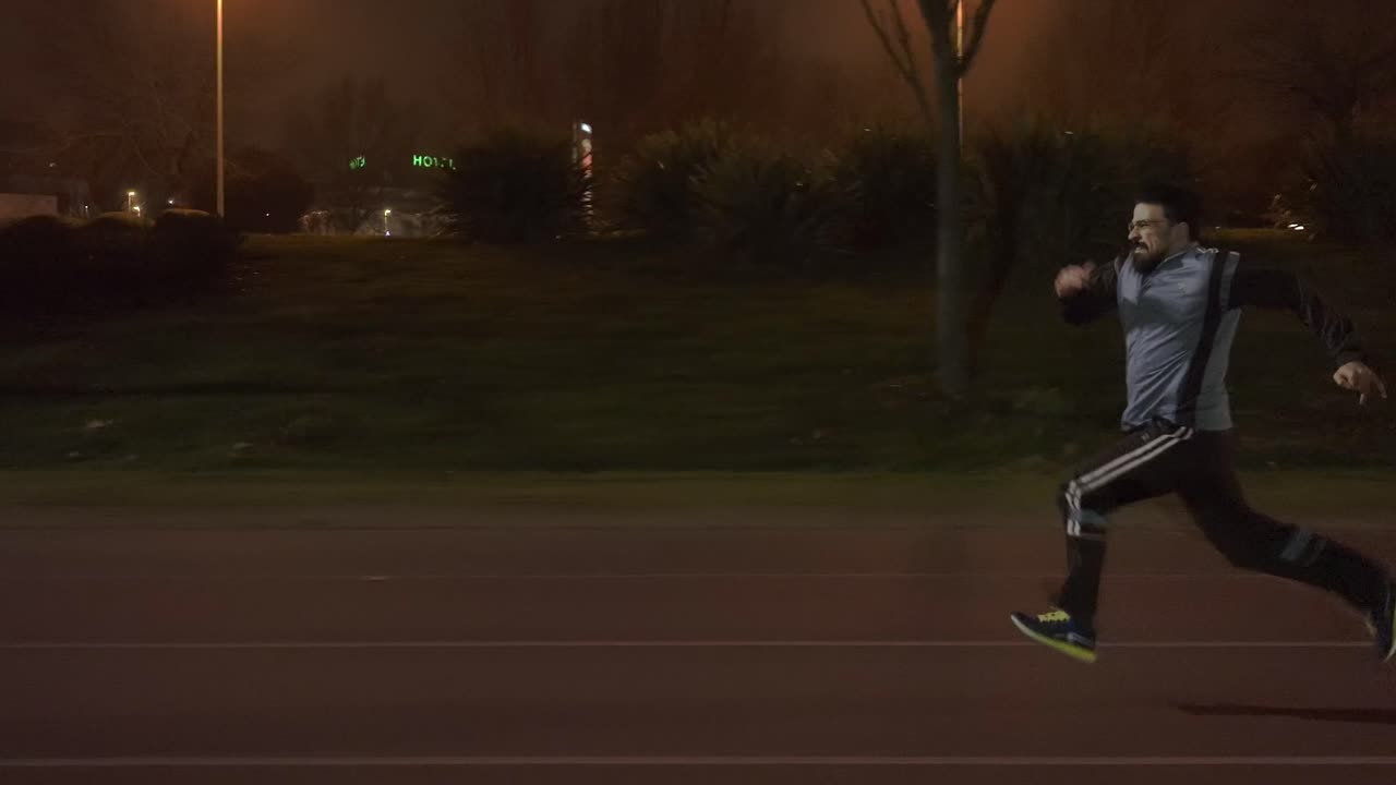 Tracking Shot of Person Increasing His Speed While Running at night