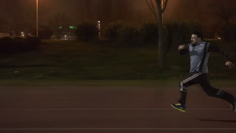 Tracking-Shot-of-Person-Increasing-His-Speed-While-Running-at-night