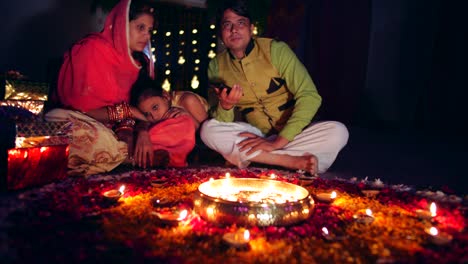 young parents with daughter celebrate decorate for diwali festival