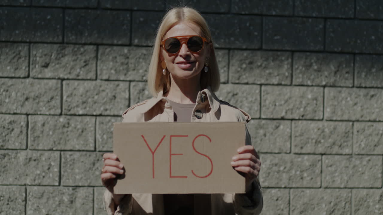 Woman holding a 'Yes' sign