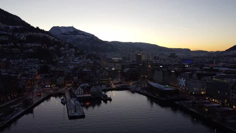 aerial shot towards bergen downtown through bergen harbour, epic first morning lights