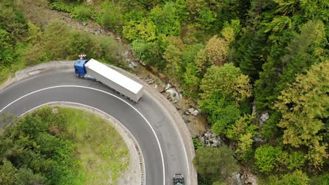 semi-trailer truck and cars driving on curve road at cheile bicazului-hasmas national park in romania