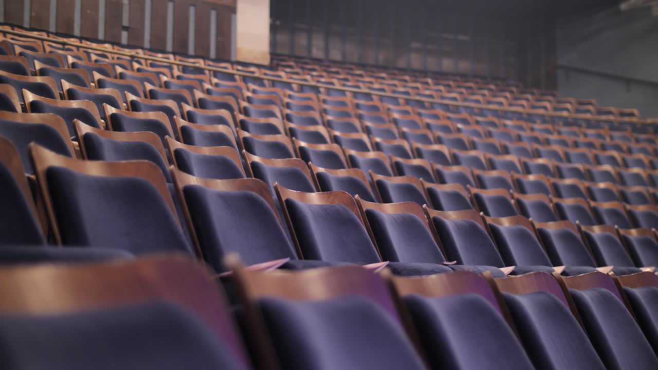 Rows of empty chairs, rack focus of elegant seats in auditorium, theater, cinema