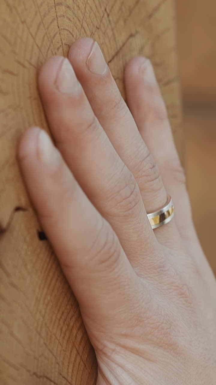 Gentleman with wedding ring touches natural log wall of rural house in village close view slow motion. Businessman enjoys beauty of countryside