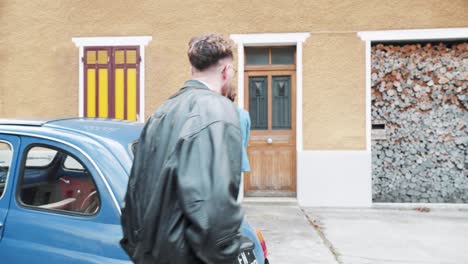 two young adults walking towards a house