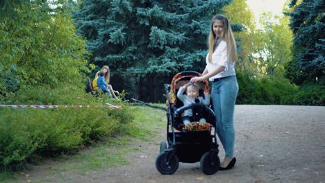 young mother with two sons is sitting on bench