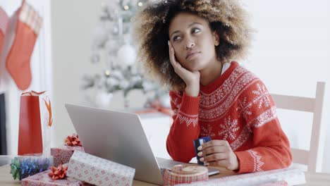 Young-woman-pondering-over-an-online-purchase