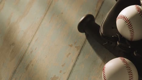 close up studio baseball still life with bat ball and catchers mitt on aged wooden floor 1