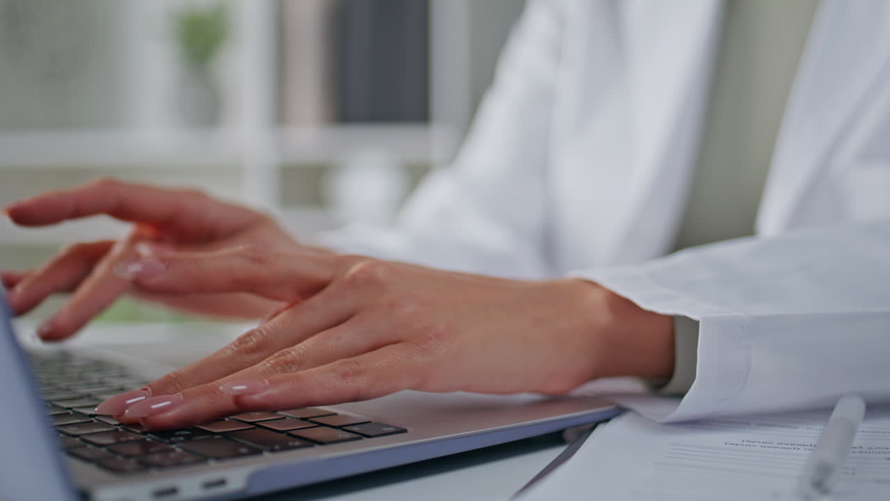 Medic hands typing laptop in light office space closeup. Unknown woman physician