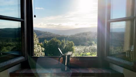 Steaming-hot-coffee-in-a-espresso-maker-on-a-window-sill-in-the-morning-with-a-beautiful-landscape-in-the-background