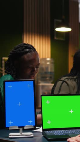 vertical video multiethnic team of experts in a meeting with a chroma key laptop
