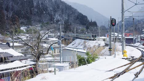 train departing yamadera station in yamagata japan, snowy winter landscape 4k