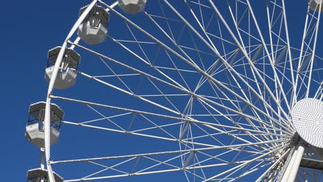 ferris wheel in action againts a blue sky.