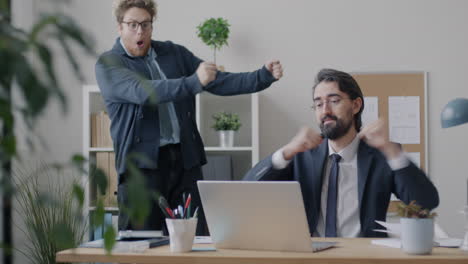 two businessmen celebrating success in office