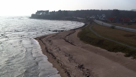 drone flight over the beach with light waves, no people on the beach