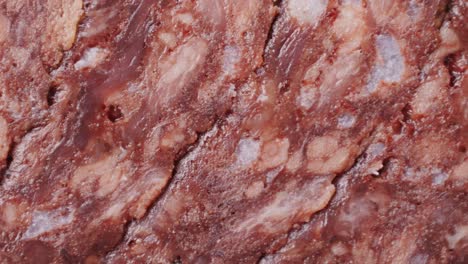 black bull sausage ham, tongue pork dry-cured sausage on a black background, traditional spanish delicatessen food, close up.