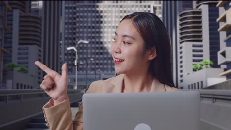 business woman working on laptop in city