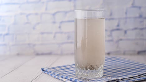 glass of cloudy water on a napkin