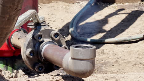 metal pipe emitting gas into the air. close up. drilling site of natural resources.