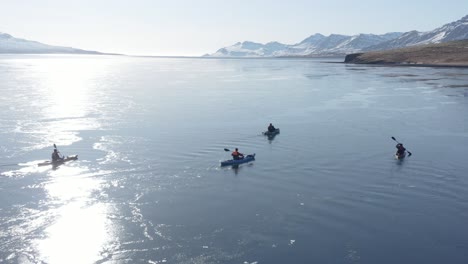 canoe adventure trip in waveless eskifjörður fjord with bright sunlight