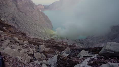 rugged and rocky crater of ijen volcano with toxic smoke in east java, indonesia. - tiltup shot