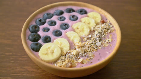 yogurt or yoghurt smoothie bowl with blue berry, banana and granola - healthy food style