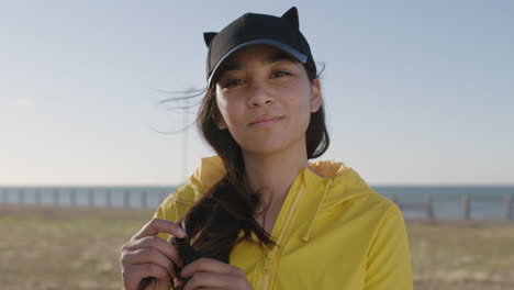 portrait of awkward teenage girl smiling cheerful looking at camera wearing braces enjoying sunny seaside park