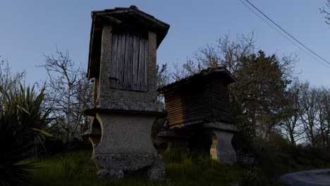 traditional galician granaries built in granite and wood at the sunset