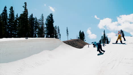 Male-Snowboarder-training-olympics-Halfpipe-aerial-double-cork-flip-slide-to-the-left-huge-air-spring-blue-sky-sunny-day-at-Mammoth-California