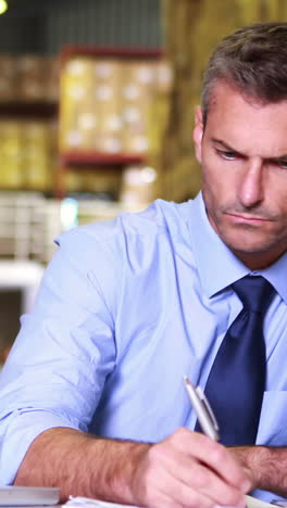 warehouse manager working on laptop