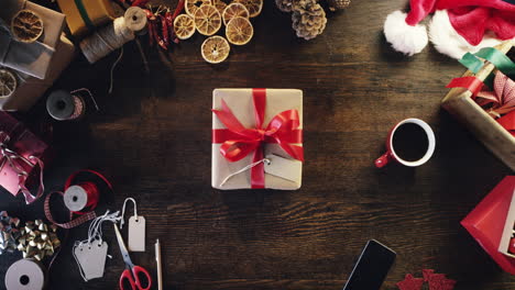 top view woman holding christmas present  at desk hands from above - red epic dragon