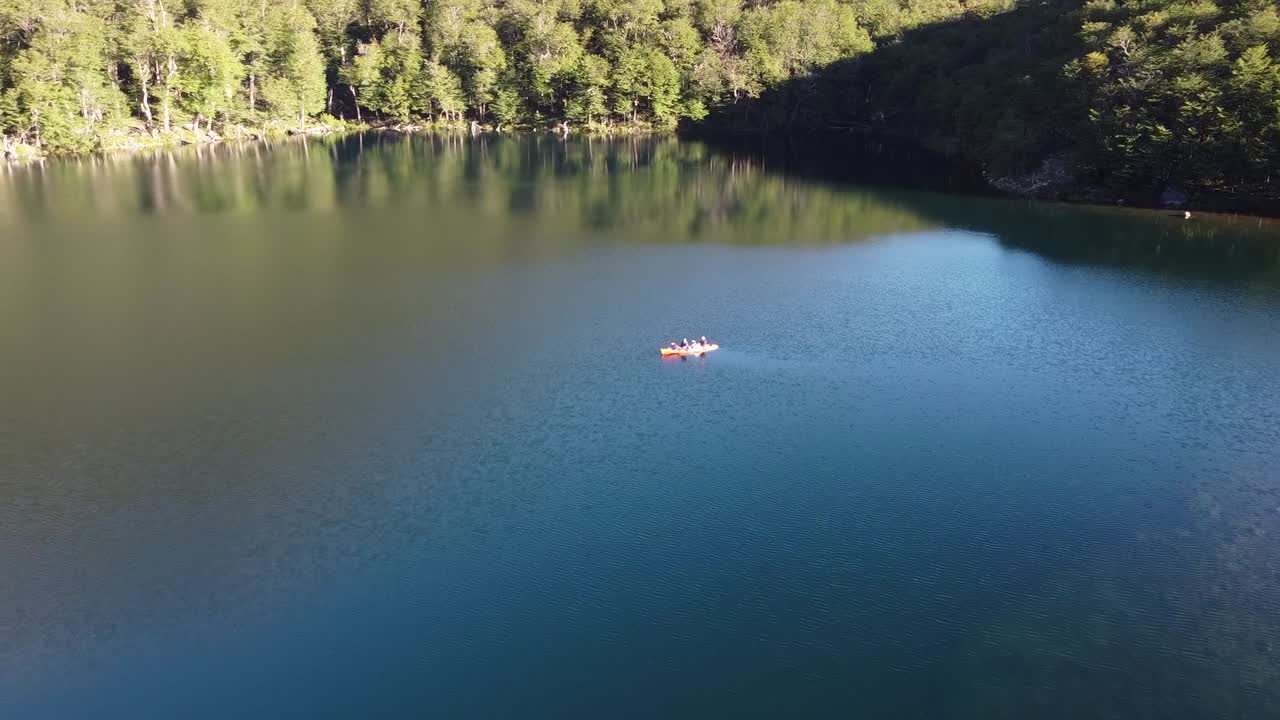 birdseye view drone shot over a couple kayaking in an outstanding lake in patagonia Argenina