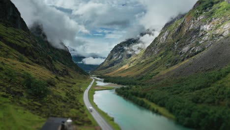 A-road-winds-along-the-river-through-the-green-Norwegian-valley