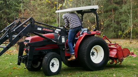 farmer operating a tractor in a rural setting